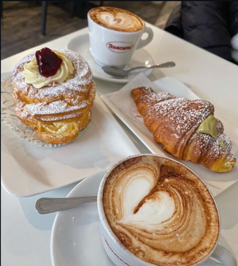 Cappuccino and two cornetti on a bar counter in Rome
