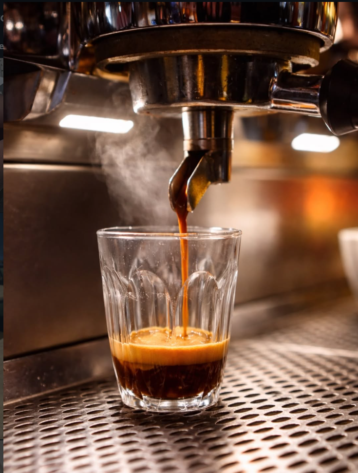 Espresso pouring into a glass at a Roman bar
