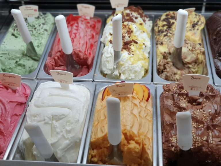 Artisanal gelato counter with trays of colourful flavours