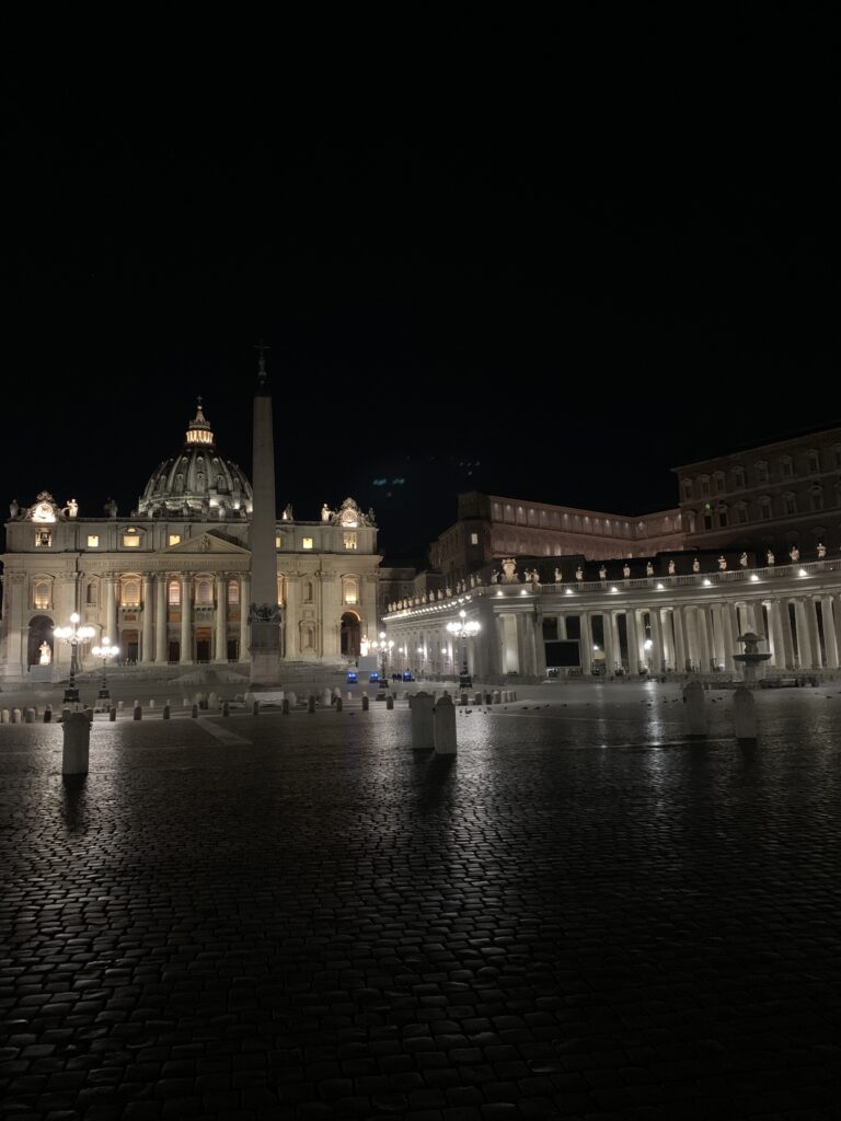 Bernini's colonnade and St. Peter's Basilica lit up at night
