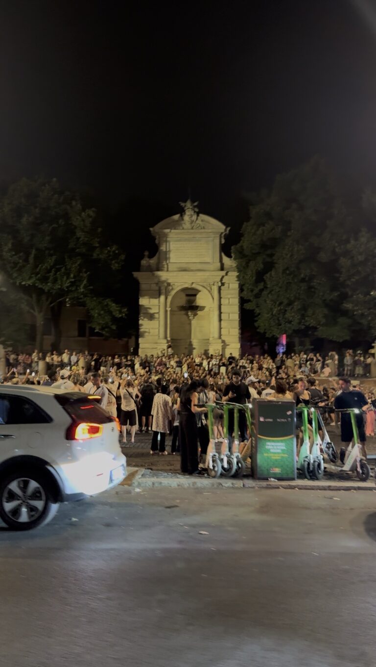 Crowds filling Piazza Trilussa in Trastevere at midnight