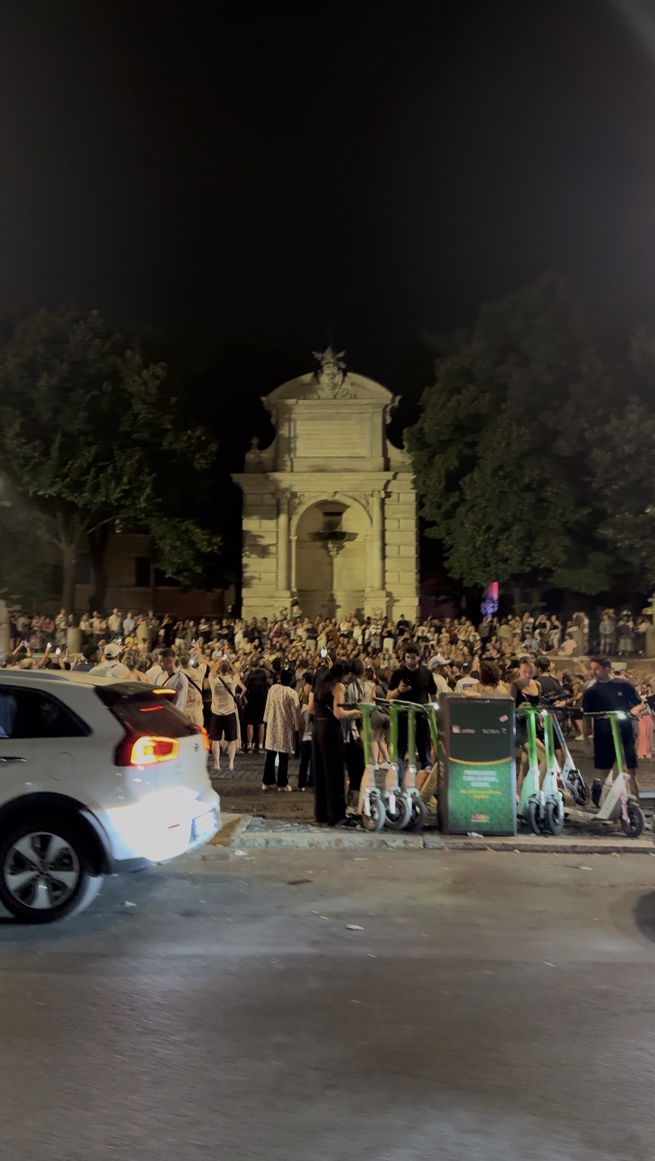 Crowds filling Piazza Trilussa in Trastevere at midnight