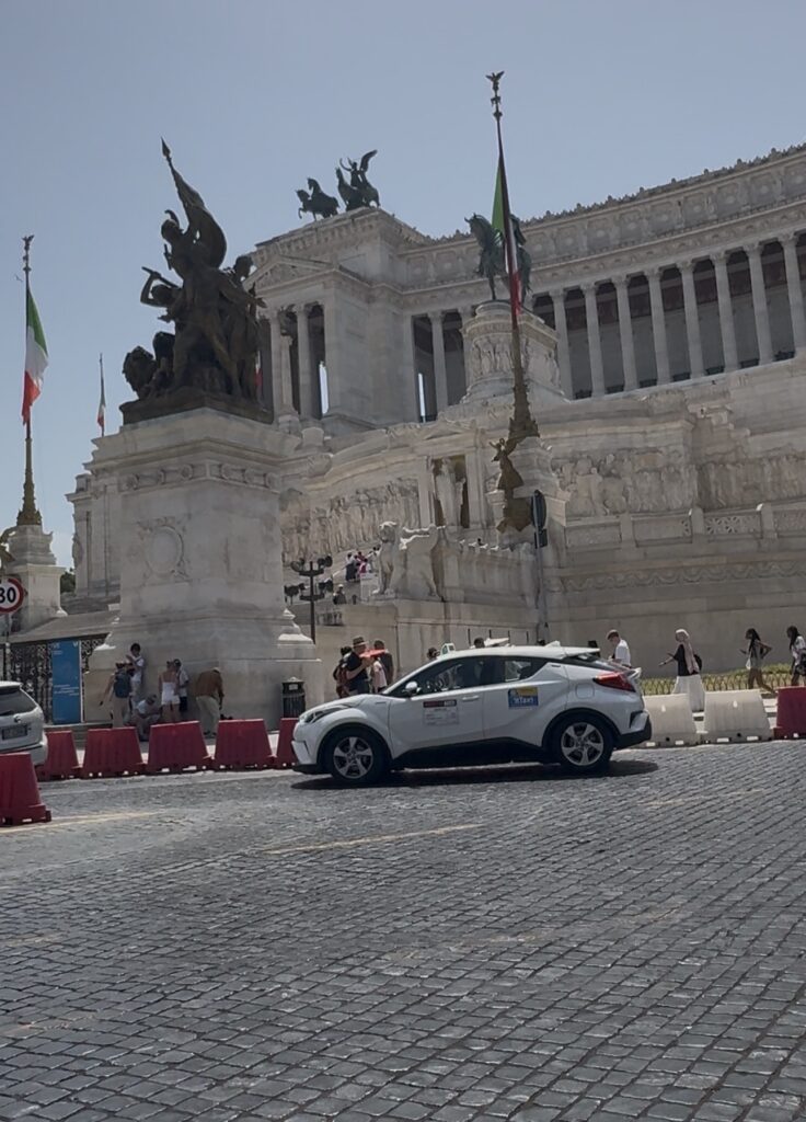 Taxis waiting in front of the Vittoriano monument in Rome