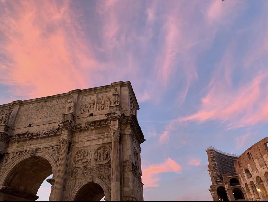 Pink October sky over the Arch of Constantine and the Colosseum